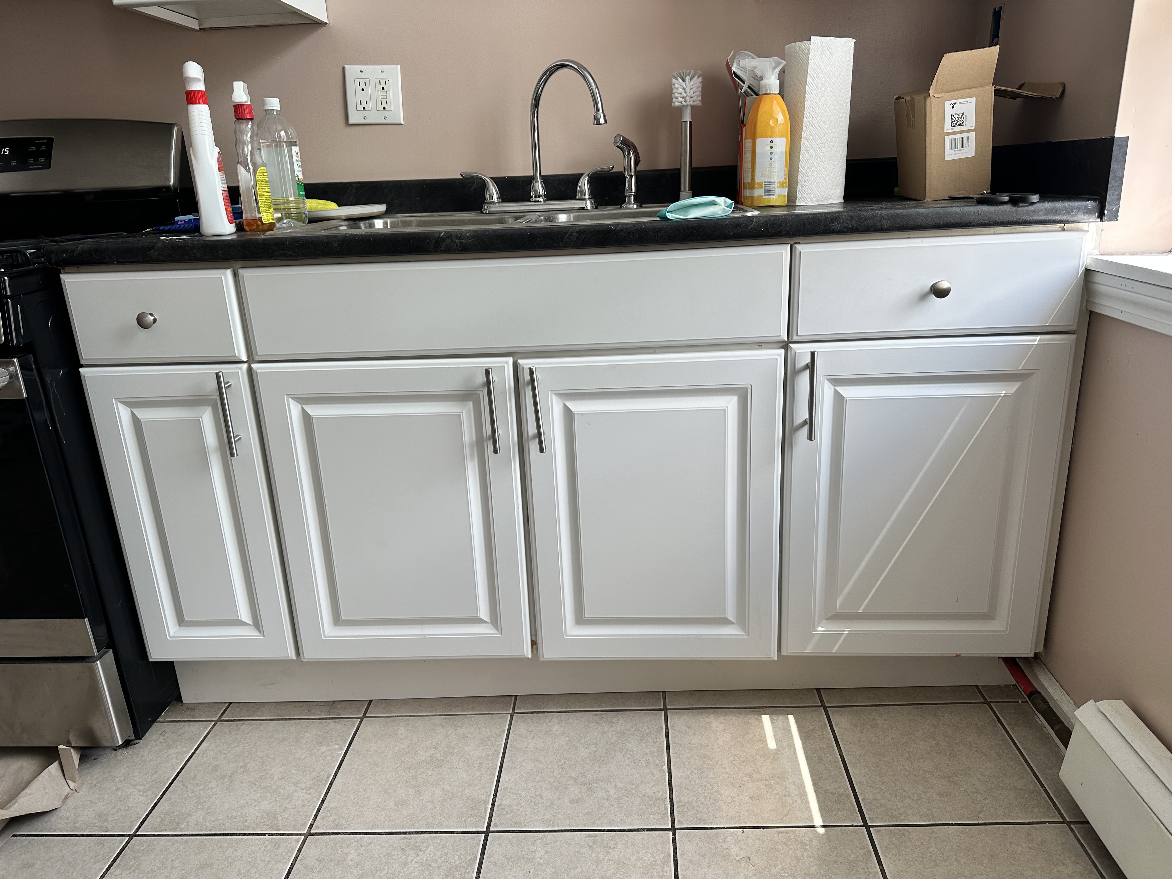 Kitchen sink cabinet exterior after repair and cleanup
