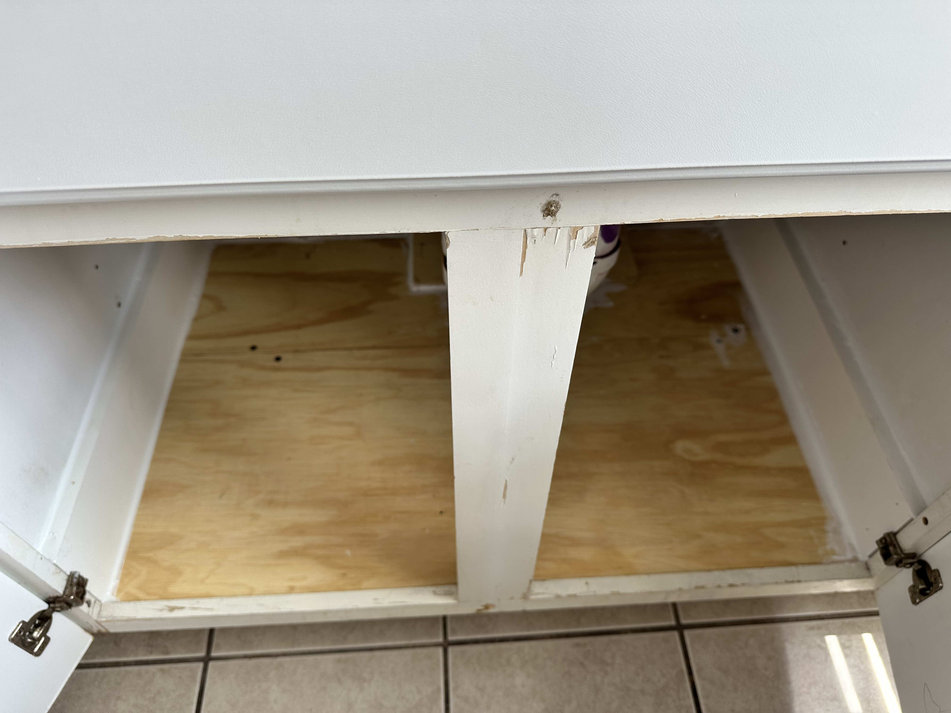 Kitchen sink cabinet after installation of a new plywood base