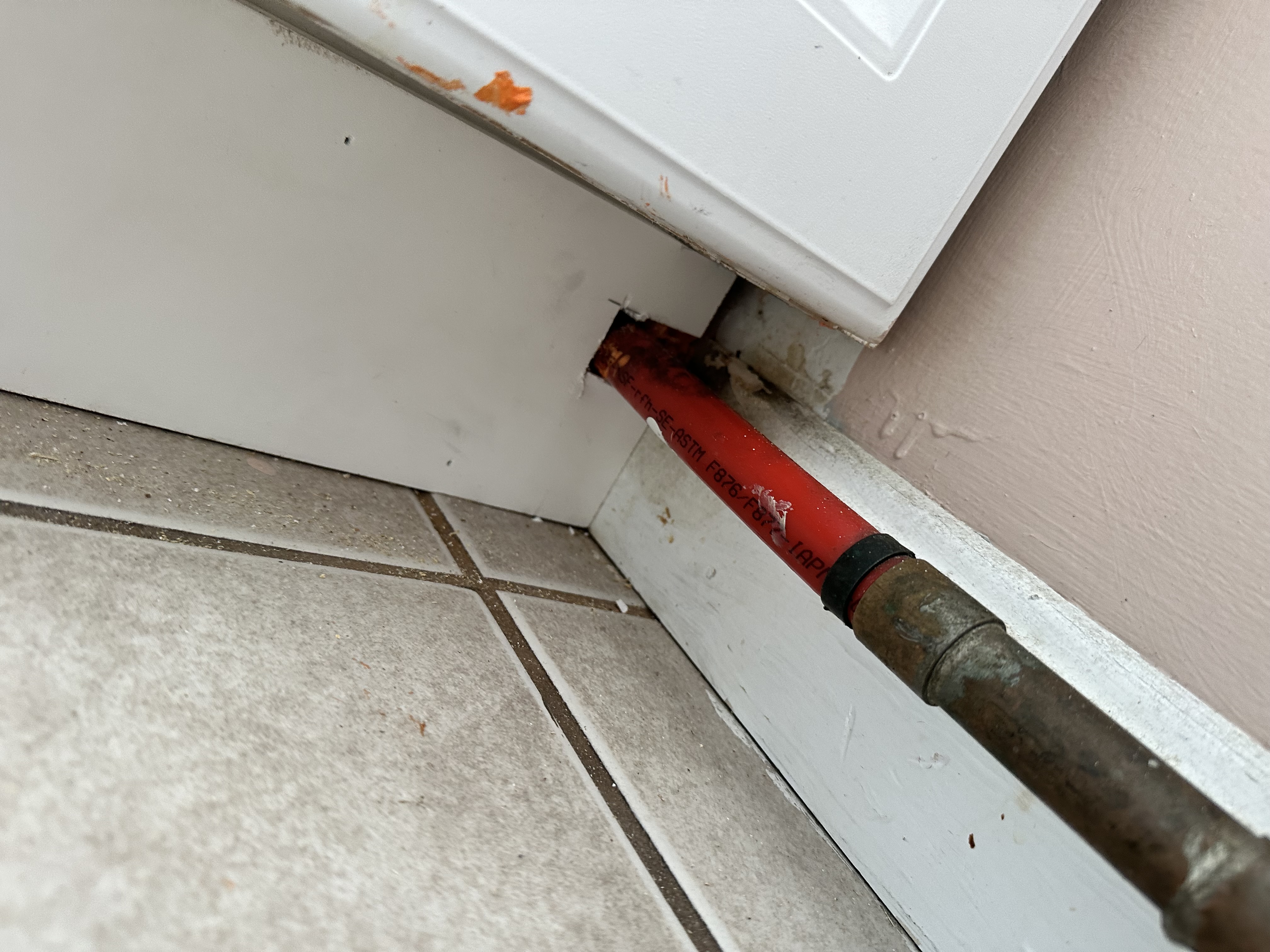 Repaired toe-kick area beside the kitchen cabinet
