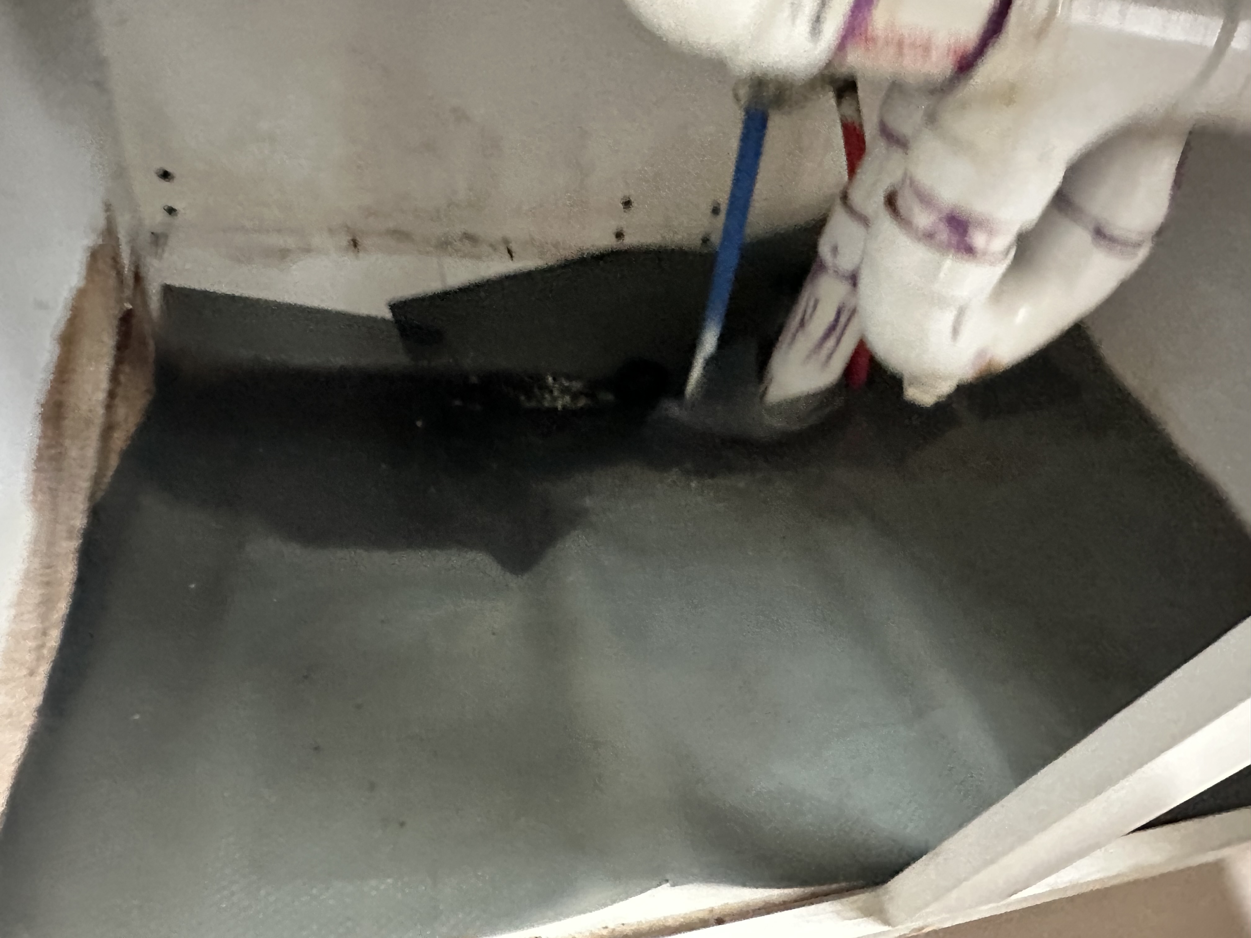 Wet cabinet bottom around the sink plumbing before repair